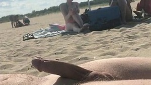Cumming on a public beach in front of two girls