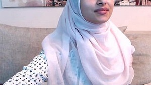 Unpaid handsome robust Arab neck pain teen poses on webcam with exposed skin