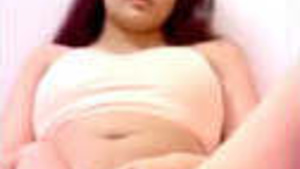 Beautiful young girl pleasures herself with her fingers