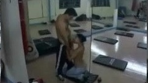 At the gym, a hot babe gives her lover a blowjob