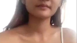 Cute and horny asian girl masturbating by the bottle