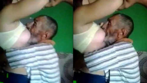Arab chubby woman gives milk to an old man while on vacation