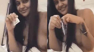 Punjabi girl takes a condom on her big breasts