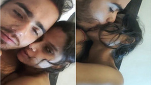 Indian chick dramatically kisses her partner in bed in soft porn music video