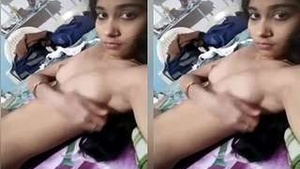 Exclusive video of a sexy girl showing off her breasts and fingering herself