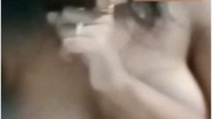 Cute Desi girl shows her big tits and fingering