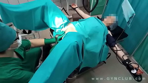 A gynecologist has fun with a patient