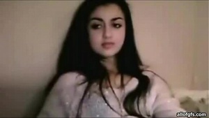 Beautiful woman playing with pussy with long black hair in robe sitting on bed