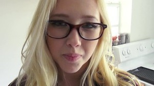 Flaxen-haired shepherdess in glasses, sly in excitement as she screwed up