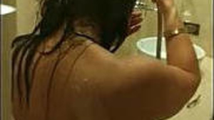 Elegant desi woman showers in a hotel, husband records