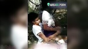 A young Tamil school girl with small breasts has fun having sex outside in the woods.