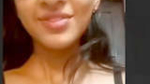 A cute Indian woman performing during a video call.