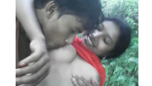 Beautiful woman’s breasts exposed and kissed by her lover in the woods