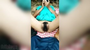 An Indian village school girl displaying her pussy outdoors