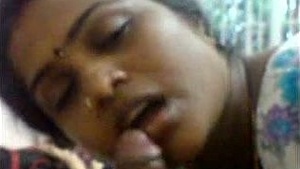 Softcore content with a mature Indian woman involved in sexual activity.