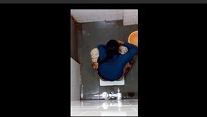 Changing the toilet pad in the bathroom of an Indian girl.