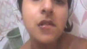 Pretty Indian babe with big melons pleases herself.