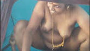 A mature India woman enjoying sex with her husband on top.