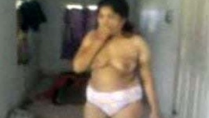 Beautiful Indian woman gives her husband a blowjob and presents him her big boobs and her large behind.