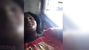 Still from a South Indian movie showing a homemade video of an aunt with large breast and hairy armpit.