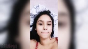 Beautiful college woman in a hotel room relaxes and exposes herself to video call companions