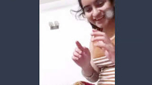 Pretty girlfriend performs for her sweetheart via video call.