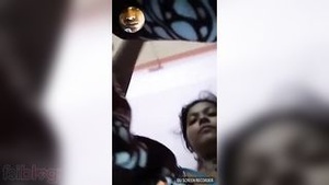 An Indian girl with large breasts has a video call with the man she loves.