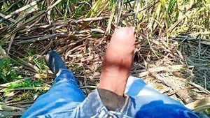 A cameraman videos a woman enjoying sex outside in a park.