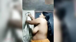 Video of Indian mature woman stripping and flashing her breasts.