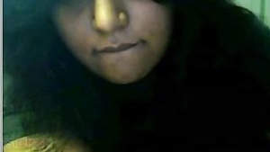 College girl with natural big boobs and tight ass from India performing a striptease.