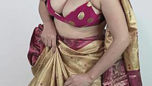 Married aunt in a sari, exposing her large breasts and her belly button.