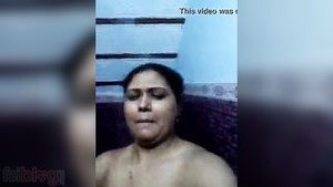A hot Indian wife is shown bathing in a solo scene in the bathroom.