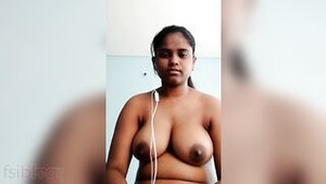 A voluptuous woman seductively exposes her breasts via webcam to a man she is calling.