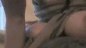 A woman with large breasts has an orgy alone with a sex toy.