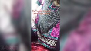 A busty woman slowly undresses and probes her own anus with her fingers in a porn video.