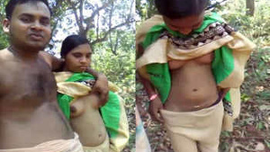 Pretty Indian couple enjoying love making in a mountain meadow