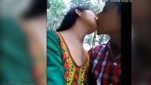 Young Indian adult couple enjoying pleasure in a park in music video