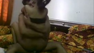 Young couple enjoys sexual experience at home while watching adult movies.