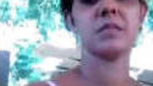 A mature woman exposes her breasts and shaved genitalia.