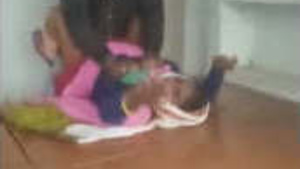 An auntie’s big boobs are exposed and she is being fucked on camera by another man.