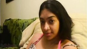 Beautiful Indian woman masturbates her pussy by rubbing it with her fingers.