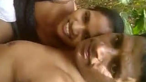 Love birds enjoying nature and fondling each other’s breasts.