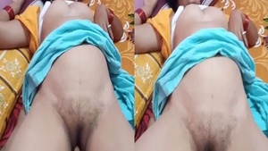 A mature Indian woman masturbates in front of the camera.