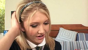 A petite girl in a uniform kneeling on her haunches with white socks is having rough sex with a towable toy.