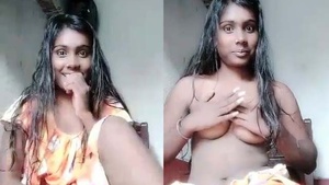A shy Indian college student exposes her breasts in front of the camera.