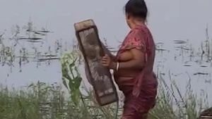 Mature aunt with small bosom wears a blouse.