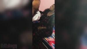 An elderly Indian housewife gives a blowjob to a big black cock for a home video.