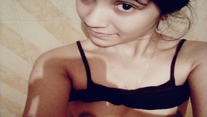 Single beauty showing her bare breasts in a home video