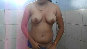 A hot Indian woman undresses and exposes herself in the bathroom and masturbates.