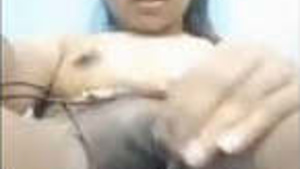 A young Tamil woman exposes her breasts and her vagina which is lubricated.